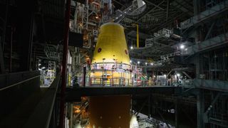 A massive crane lowers the launch vehicle stage adapter onto the SLS (Space Launch System) core stage on Thursday, April 3, 2025, in High Bay 3 inside the Vehicle Assembly Building at NASA’s Kennedy Space Center in Florida.