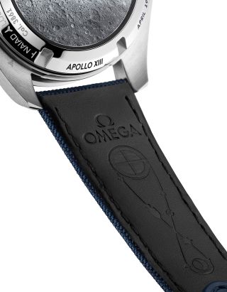 The Apollo 13 trajectory from Earth to the moon and back appears on the lining of the "Silver Snoopy Award" 50th Anniversary Omega Speedmaster nylon fabric strap.
