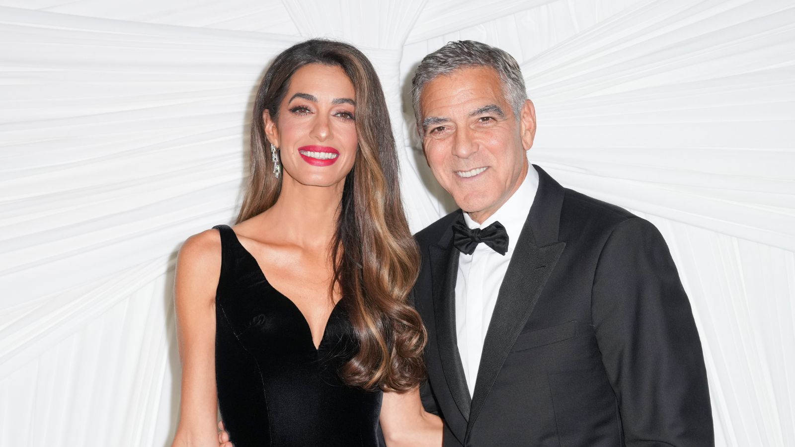george and amal clooney on a white background