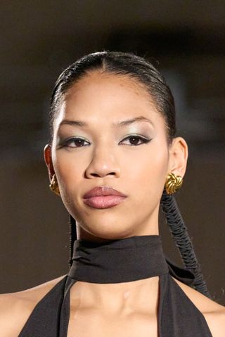 A model at Tia Adeola wearing flicked liner, a key Fashion Week Autumn/Winter 25 beauty look