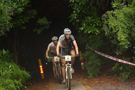 Victorian Paul van der Ploeg has Hobart Olympian Sid Taberlay hot on his wheel as he exits the Spray Tunnel on the Zeehan Time Trial stage