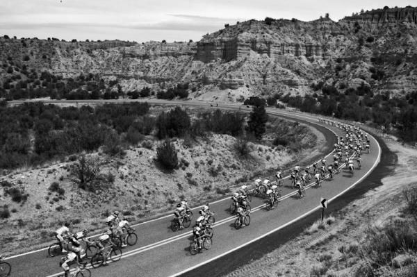 The men's field descends through a deep canyon on the way to Mogollon.