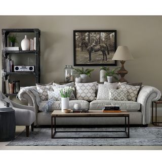 living room with white sofa set having printed cushions