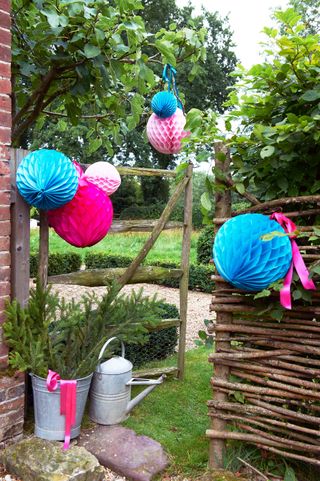 woven fence panel with paper lanterns