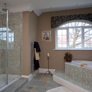bathroom with shower area and towels