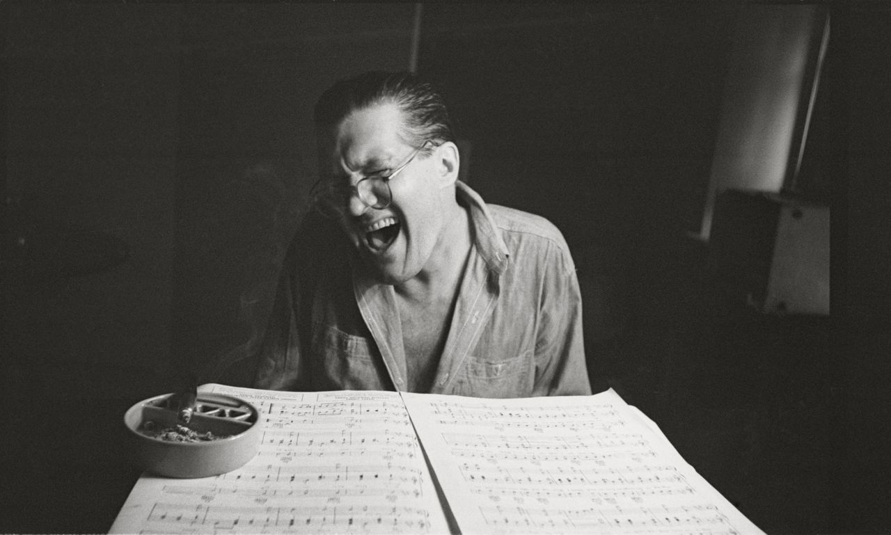 Black and white image- Peter Arno... Sophisticated Cartoonist, 1949, by Stanley Kubrick. Arno plays the piano in his Park Avenue apartment