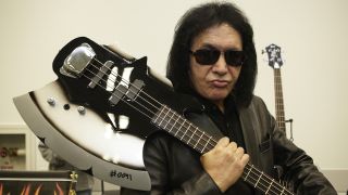 Gene Simmons of Kiss poses with the Cort GS-Axe-2 bass at the 2010 NAMM show at Anaheim Convention Center on January 13, 2010 in Anaheim, California.