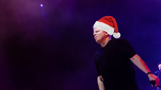 A photo of The Offsrping singer Dexter Holland, digitally modified to include a Santa hat on his head