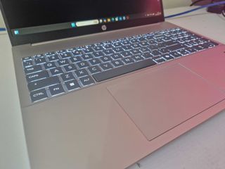 A silver HP Pavilion 16 sitting on a white desk