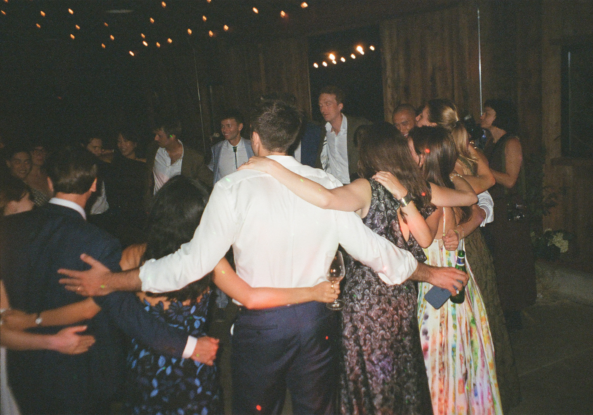 Their friends dancing in a circle.
