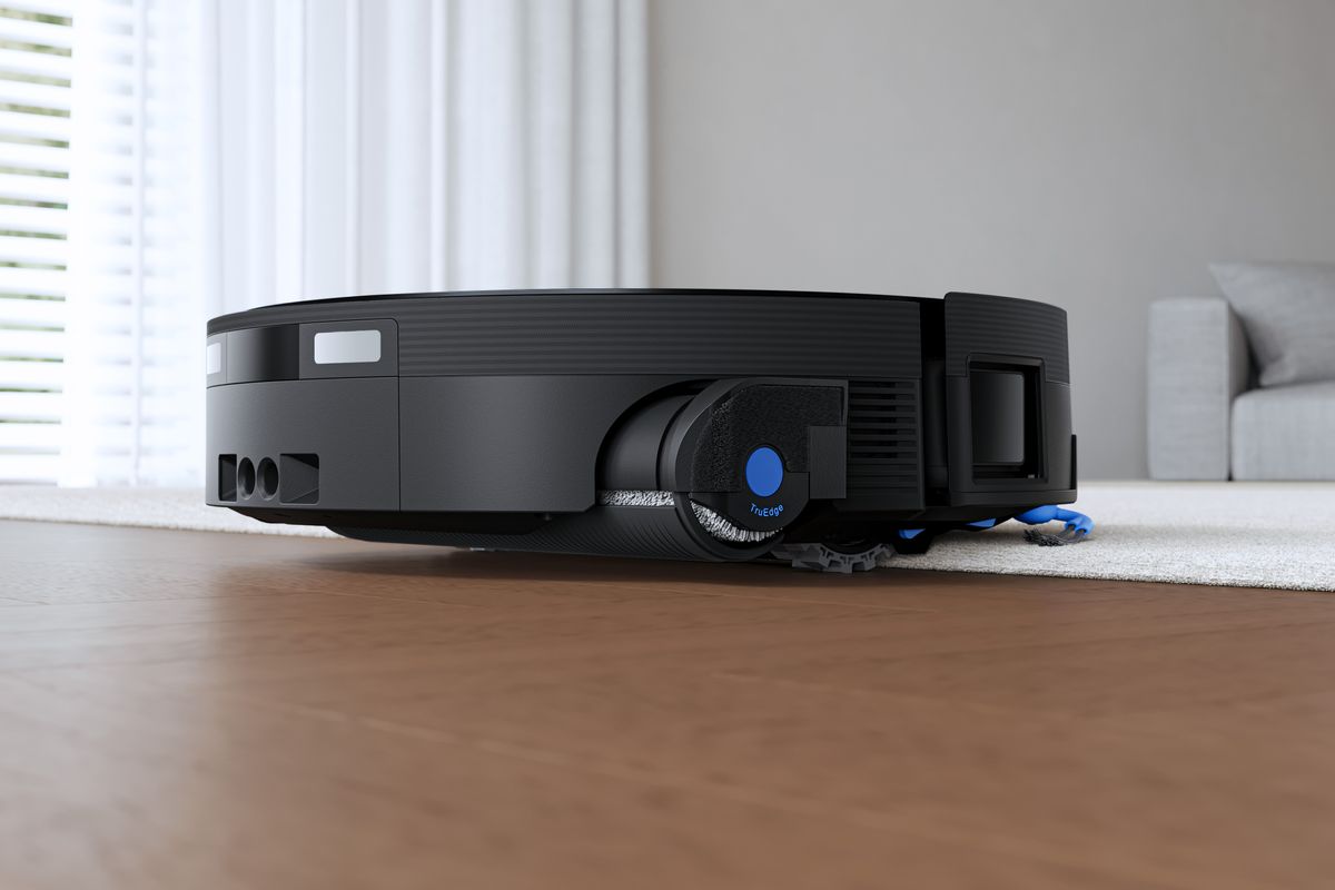 Ecovacs Deebot X12 OmniCyclone robot vacuum moving between carpet and hard floor
