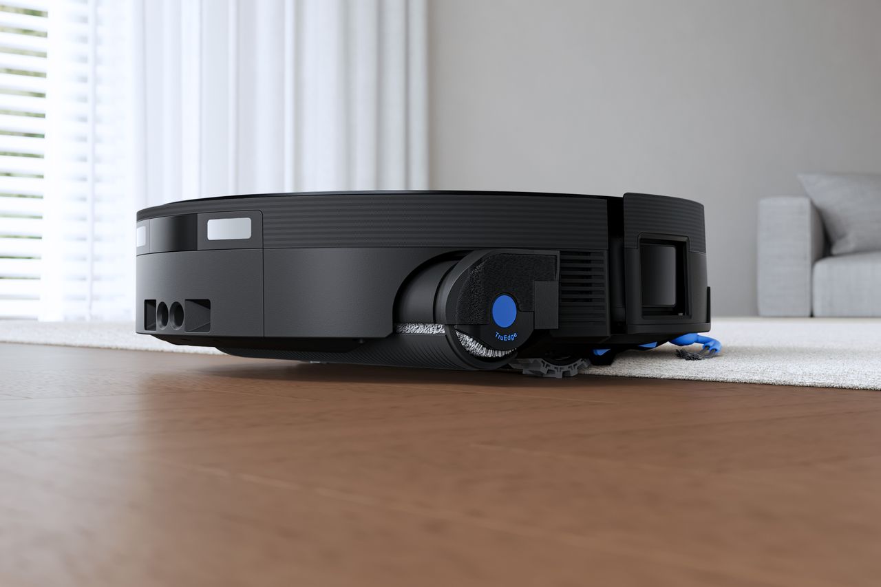 Ecovacs Deebot X12 OmniCyclone robot vacuum moving between carpet and hard floor