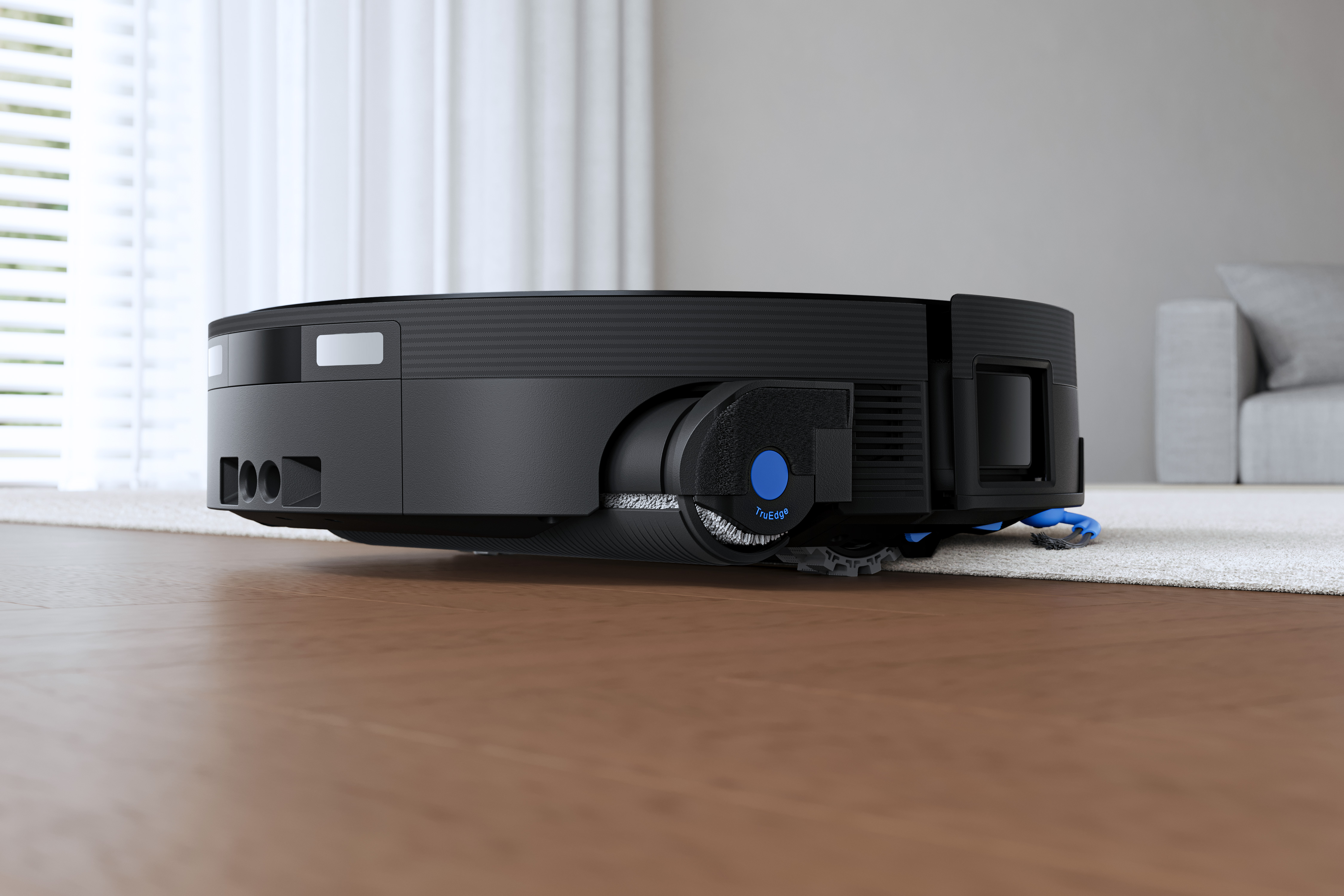 Ecovacs Deebot X12 OmniCyclone robot vacuum moving between carpet and hard floor