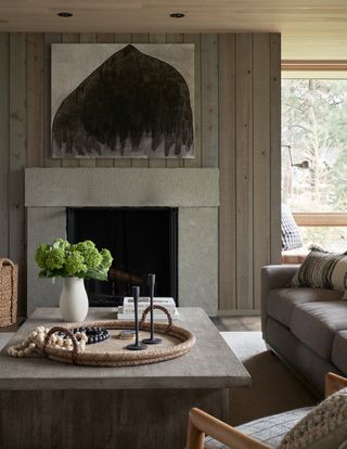 Rustic grey living room with simple stone fireplace