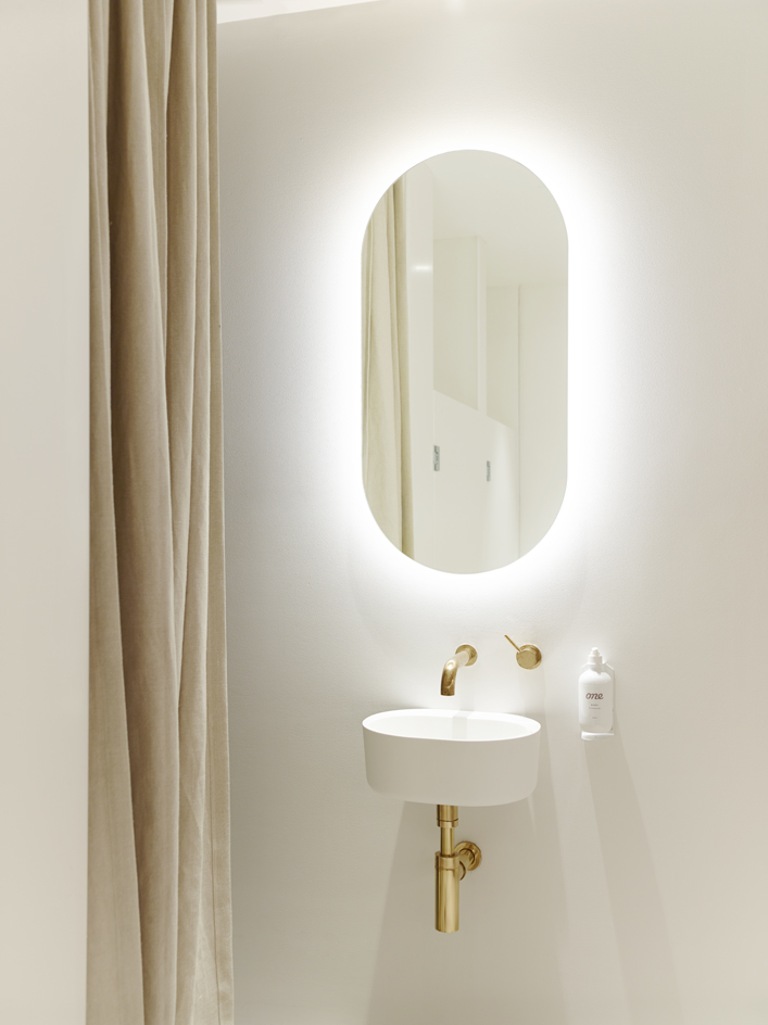 Mirrors with brass details punctuate the space throughout