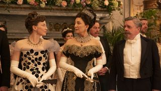 10 best The Gilded Age costumes. Pictured: Carrie Coon stares at Donna Murphy with Nathan Lane standing next to them in The Gilded Age