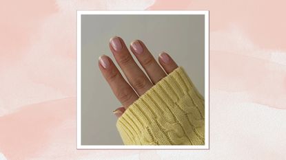 A close-up of a hand with square, butter-yellow French tip nails by nail artist Fliss Alton (@gelsbyfliss) and a yellow jumper sleeve visible, covering the back of the hand and wrist/ featured in a pink watercolour paint-style template