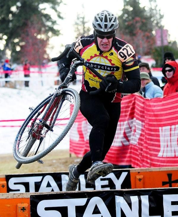 John Rollert (Webcyclery) racing over the barriers.