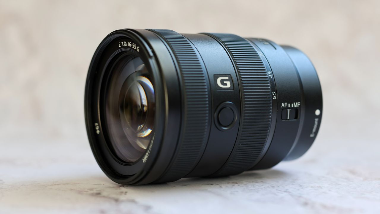 Sony E 16-55mm f/2.8 G Lens placed on a surface with a marbled background