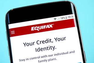 Equifax logo and slogan displayed on a smartphone.