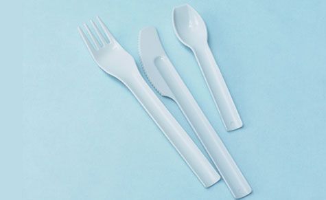 White spoon with sky blue background