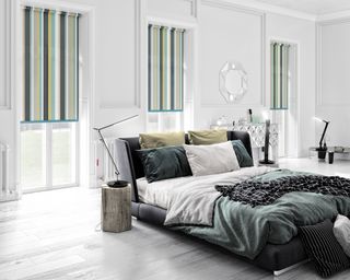 Green bedroom with striped roller blinds by English Blinds