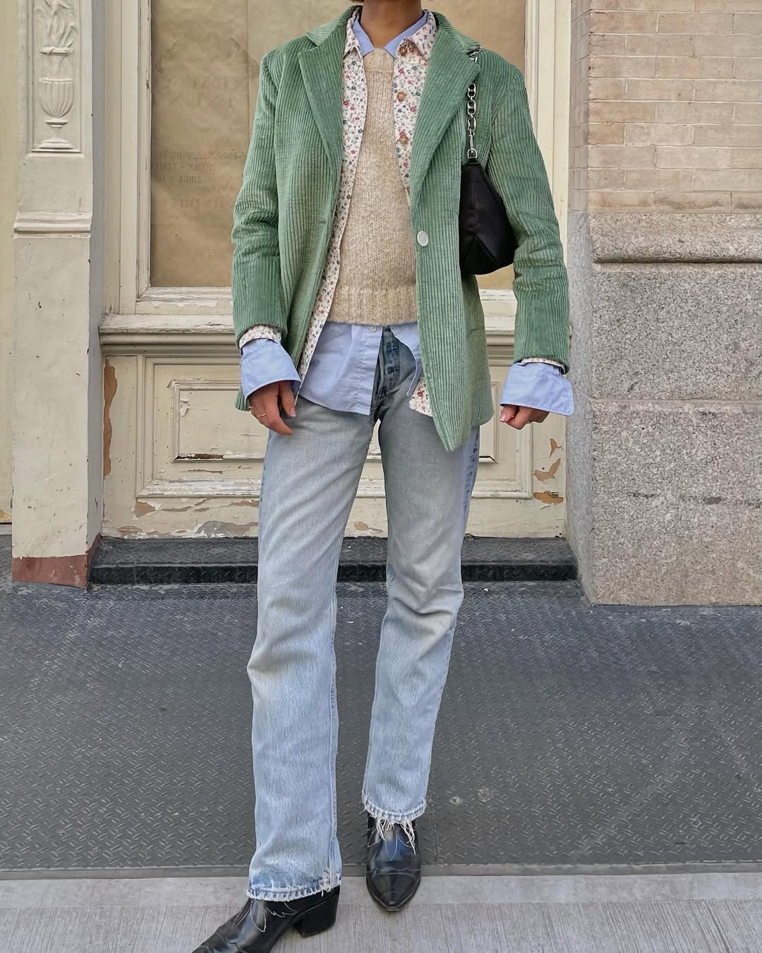 woman wearing slim jeans and green blazer with boots