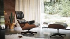 Designer furniture: Eames recliner chair in living room by large window