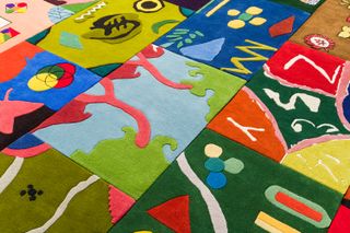 A grid of colourful rugs, from an initiative by Alex Proba, Little Proba and the Toni Garrn Foundation