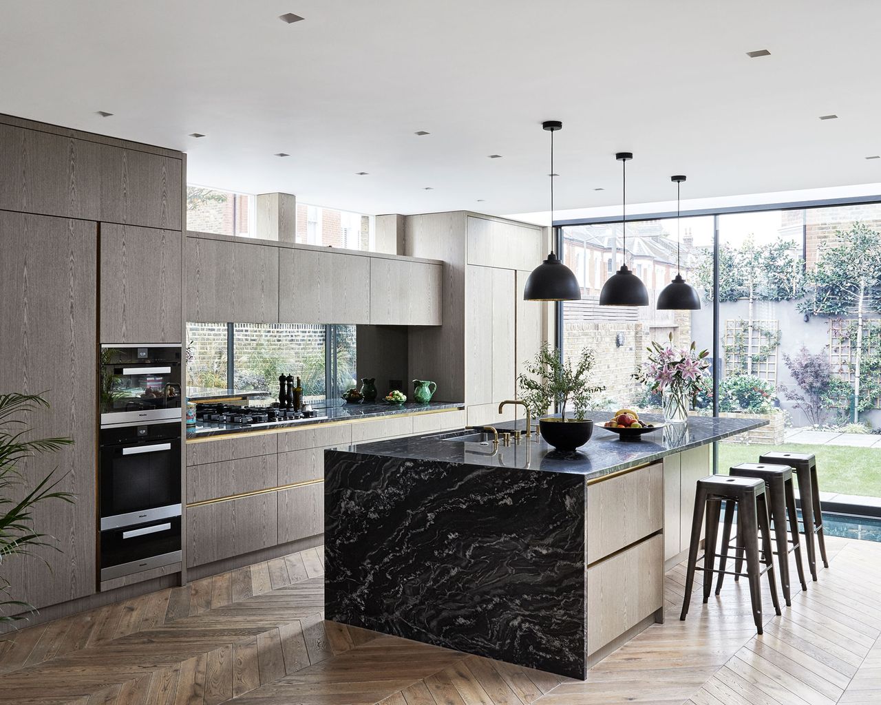 Grey kitchen with wooden cabinetry and flooring