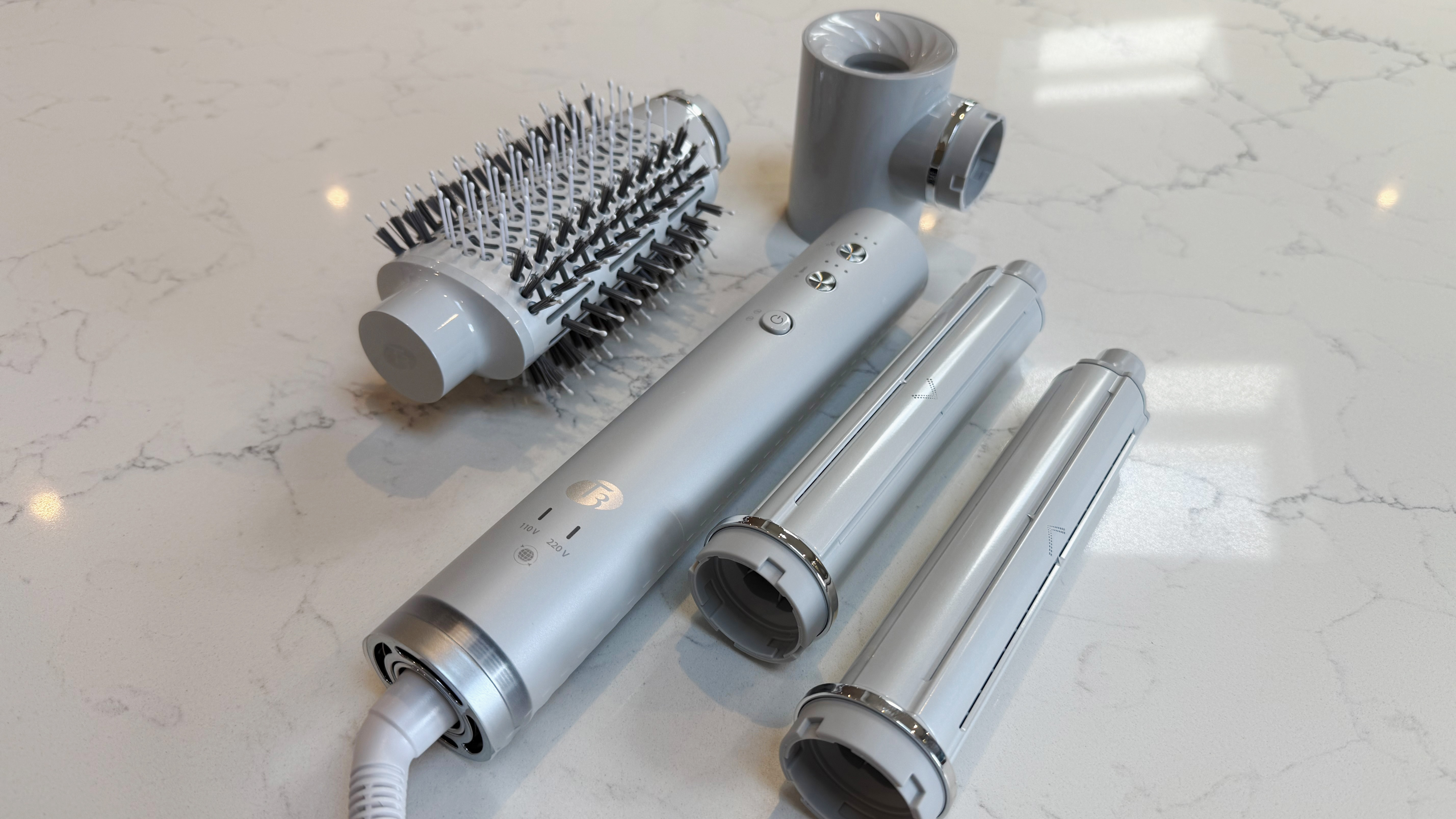 The T3 Aire 360 base surrounded by attachments &ndash; oval brush, SoftAire drying concentrator and two ceramic curling barrels