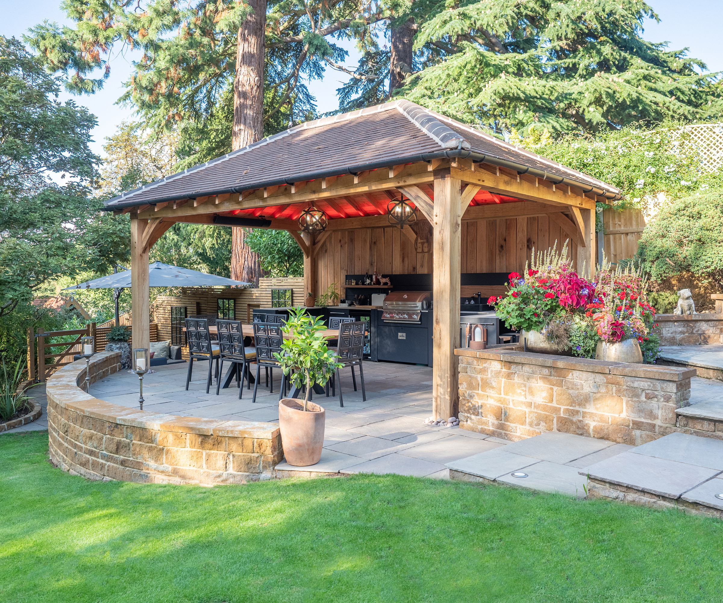 pergola with tiled roof over kitchen area and seating