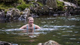 Woman wild swimming in lake