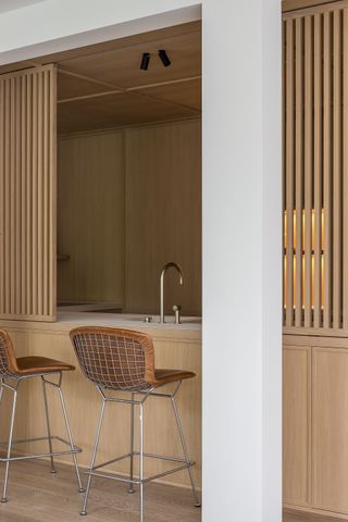 wood kitchen with slatted partition across the island