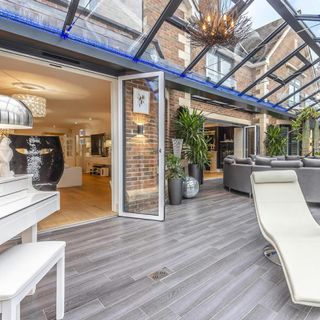 conservatory with glass roof potted plant and glass door