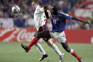 Wayne Rooney of England and Lilian Thuram of France challenge during the UEFA Euro 2004 match between France and England at Estadio Da Luz on June 13, 2004 in Lisbon, Portugal.