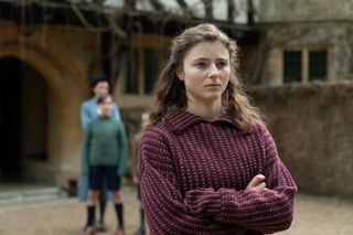 Ursula (Thomasin McKenzie) wearing a red dress as in Life After Life.