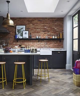 A kitchen with brick wall decor and real parquet flooring