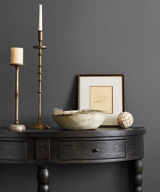 Dark gray wall with candlestick and picture frame
