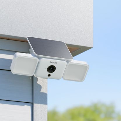 Reolink solar security camera on exterior of house in daytime