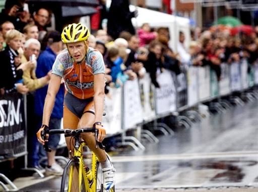 Michael Rasmussen crosses the line after taking part in the biggest race since he was thrown out of the Tour de France in 2007.