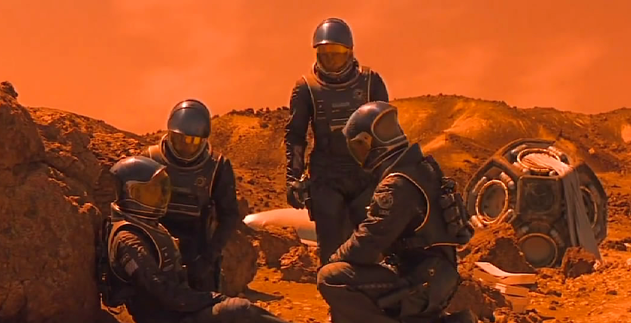 Four astronauts on Mars beside a crashed space pod