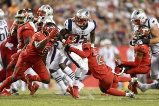 New England Patriots running back Mike Gillislee (35) is tackled by Tampa Bay Buccaneers cornerback Vernon Hargreaves III (28) and linebacker Kendell Beckwith (51) during an NFL football game on Oct. 05, 2017. 