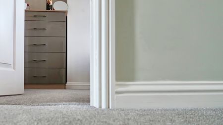 view into bedroom showing door architrave and skirting boards