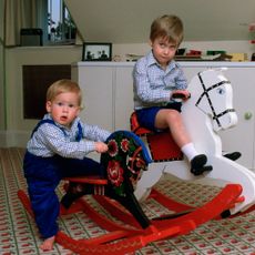 Prince William and Prince Harry on rocking horses in their play room