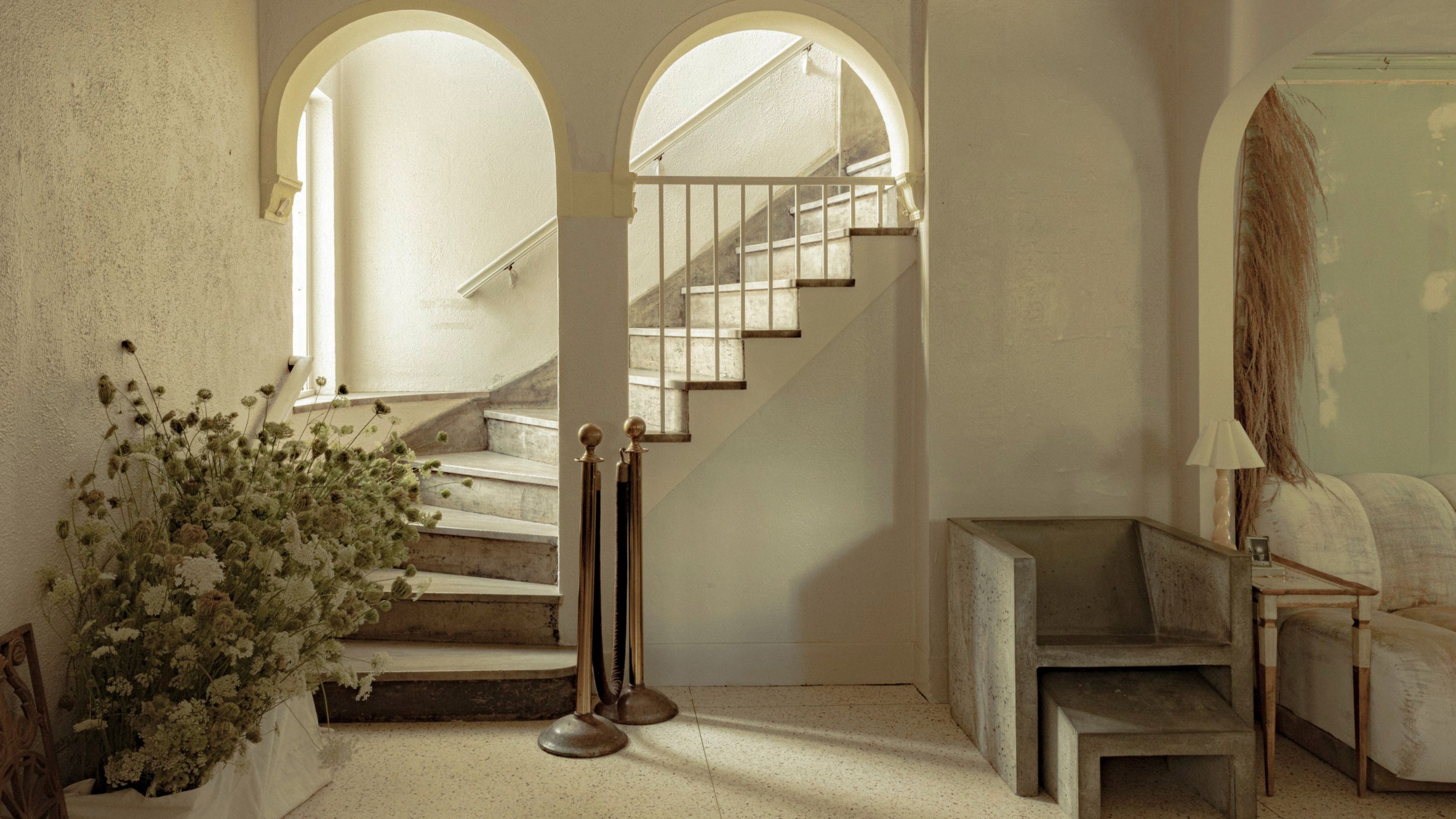 a historic staircase with arched openings and stone steps