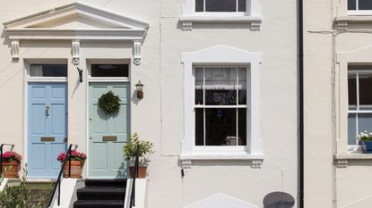 White terraced house with steps leading to the front door