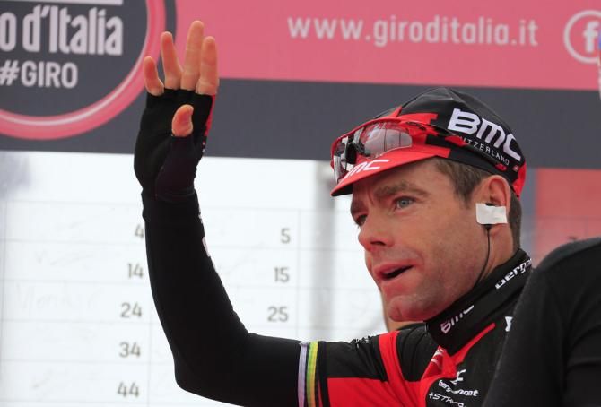 Cadel Evans waves to the crowd at the start of stage 2