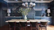 dining room with blue mural walls and paneled ceiling