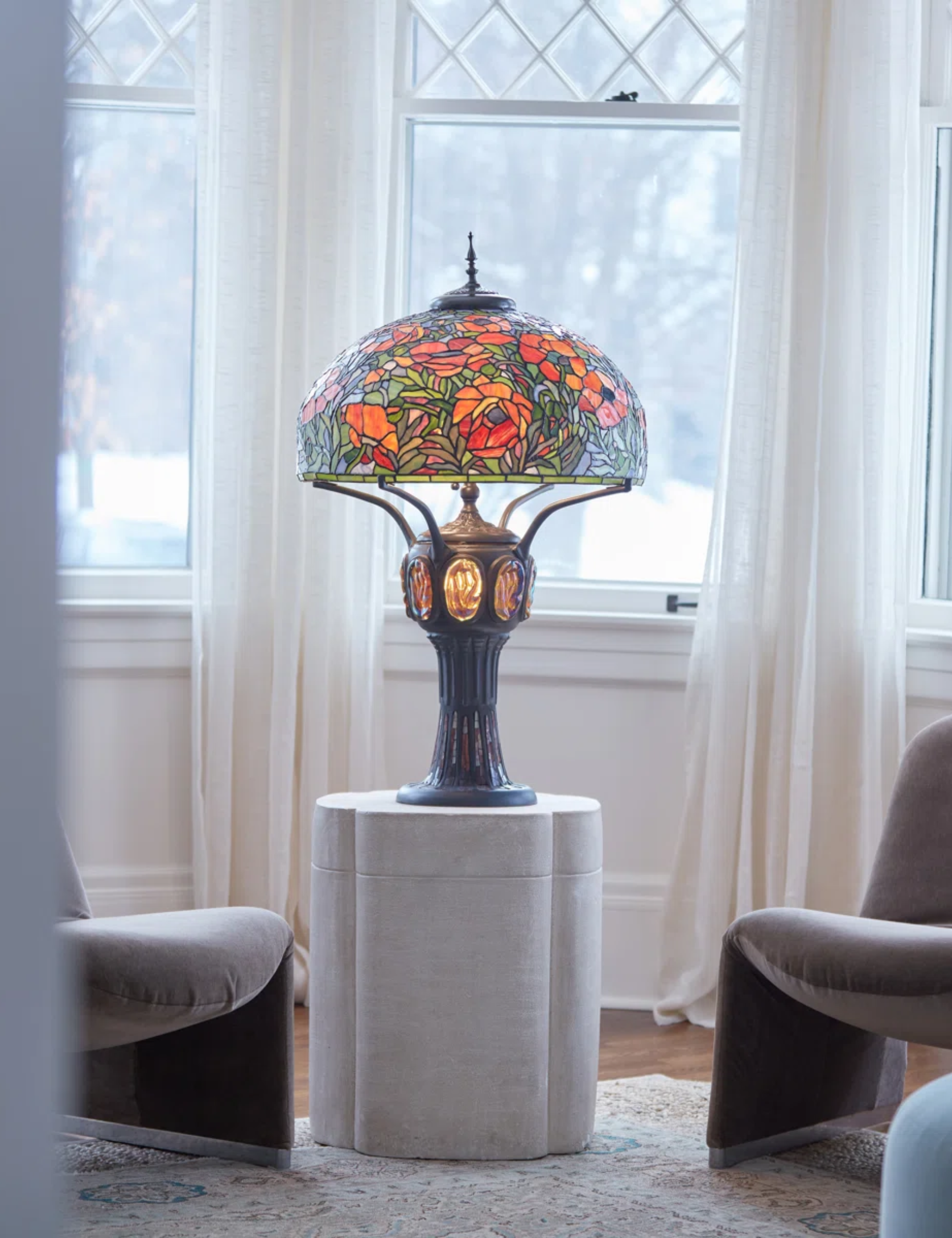 Tiffany style lamp pictured in living room alongside modern furniture